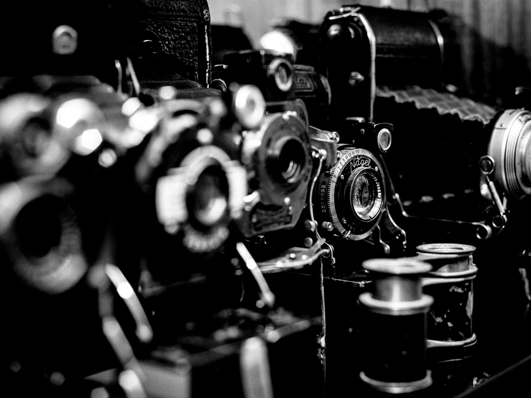 A table crowded with vintage film cameras